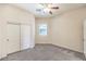 Neutral bedroom features closet, ceiling fan, and natural light at 5260 Acqua Ln, Pahrump, NV 89061