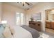 Comfortable bedroom featuring access to back yard, with door to the bathroom at 5260 Acqua Ln, Pahrump, NV 89061