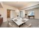 Elegant dining room with chandelier lighting and seating for six at 5260 Acqua Ln, Pahrump, NV 89061