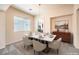 Open dining room with marble-top table set for six at 5260 Acqua Ln, Pahrump, NV 89061