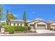 Charming home with a three-car garage, mature landscaping, and well-maintained lawn at 5260 Acqua Ln, Pahrump, NV 89061