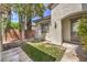 Cozy stucco home featuring an arched doorway and charming front yard with mature tree at 5260 Acqua Ln, Pahrump, NV 89061