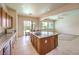 Open kitchen with an island and tile floors connected to a casual dining and living area at 5260 Acqua Ln, Pahrump, NV 89061