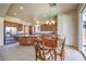 Bright open kitchen with dark wood cabinetry, stainless appliances and an adjacent dining area at 5260 Acqua Ln, Pahrump, NV 89061