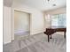 Spacious living room featuring a piano, chandelier, and carpeted flooring at 5260 Acqua Ln, Pahrump, NV 89061
