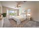 Bright main bedroom with a king bed, sliding glass doors to the backyard, and neutral decor at 5260 Acqua Ln, Pahrump, NV 89061
