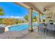 Inviting covered patio with mountain views, a pool, and an outdoor dining area at 5260 Acqua Ln, Pahrump, NV 89061
