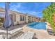 Relaxing backyard pool with a covered patio and lounge chairs, perfect for summer days at 5260 Acqua Ln, Pahrump, NV 89061