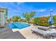 Refreshing backyard pool featuring lounge chairs for relaxation under the sunny sky at 5260 Acqua Ln, Pahrump, NV 89061