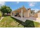 Inviting backyard with a covered patio, stone pavers, and lush lawn perfect for relaxing and entertaining outdoors at 5310 Eel River Ct, North Las Vegas, NV 89031