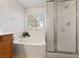 Bright bathroom featuring a soaking tub and glass enclosed shower, perfect for relaxing and unwinding at 5310 Eel River Ct, North Las Vegas, NV 89031