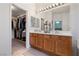 Bright bathroom features a double sink vanity and an open walk-in closet for ample storage space at 5310 Eel River Ct, North Las Vegas, NV 89031