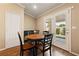 Cozy breakfast nook with round table, dark wood chairs and view of the backyard at 5310 Eel River Ct, North Las Vegas, NV 89031