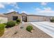 Charming single-story home with desert landscaping and three car garage at 5310 Eel River Ct, North Las Vegas, NV 89031