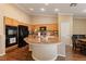 Open kitchen featuring wood cabinets, granite countertops, and a large island with seating at 5310 Eel River Ct, North Las Vegas, NV 89031