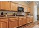 Kitchen showcasing wood cabinets, granite counters, gas cooktop and modern appliances at 5310 Eel River Ct, North Las Vegas, NV 89031