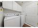 Bright laundry room with white washer and dryer at 5310 Eel River Ct, North Las Vegas, NV 89031