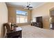 Bright living room featuring carpet floors, a large window and ceiling fan at 5310 Eel River Ct, North Las Vegas, NV 89031
