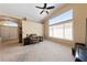 Bright living room featuring carpet floors, a large window and ceiling fan at 5310 Eel River Ct, North Las Vegas, NV 89031