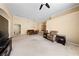 Open-concept living area with carpet flooring, neutral walls, and seamless transition to the dining area at 5310 Eel River Ct, North Las Vegas, NV 89031