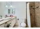 Bright bathroom featuring a tiled shower with decorative accents and a modern sink and vanity at 590 Tam O Shanter, Las Vegas, NV 89109