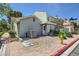 Charming townhome featuring desert landscaping, an air conditioner, and brick-paved walkways at 590 Tam O Shanter, Las Vegas, NV 89109