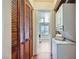 A laundry room featuring a stacked washer and dryer and wooden closet with louvered doors at 590 Tam O Shanter, Las Vegas, NV 89109