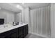 Modern bathroom with a double vanity and shower with curtain at 6247 Milford Sound St, Las Vegas, NV 89148