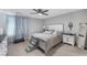 Bright bedroom featuring a comfortable bed, ceiling fan, and neutral color scheme at 6247 Milford Sound St, Las Vegas, NV 89148