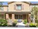 Charming two-story home features desert landscaping, a walkway, and a cozy bench by the front door at 6247 Milford Sound St, Las Vegas, NV 89148