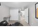 The home gym features carpeted floor and exercise equipment. There are 2 doors and a sports jersey on the wall at 6247 Milford Sound St, Las Vegas, NV 89148