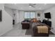 Spacious living room boasts a neutral color scheme, tiled floors, recessed lighting, and a ceiling fan at 6247 Milford Sound St, Las Vegas, NV 89148