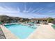 Community pool with lounge chairs and a covered area, perfect for relaxing and enjoying the outdoors at 6247 Milford Sound St, Las Vegas, NV 89148