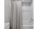 Bright bathroom shower/tub combination with neutral shower curtain and tiled wall at 6247 Milford Sound St, Las Vegas, NV 89148
