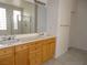 A spacious bathroom with double vanity and a large mirror at 7649 Slide Rock Ave, Las Vegas, NV 89113