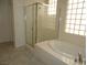 A modern bathroom features a glass enclosed shower and a soaking tub at 7649 Slide Rock Ave, Las Vegas, NV 89113