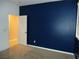 Bedroom with modern blue accent wall, carpeted floor and window at 7649 Slide Rock Ave, Las Vegas, NV 89113