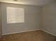 Cozy bedroom with a window, carpeted floor and neutral color palette at 7649 Slide Rock Ave, Las Vegas, NV 89113