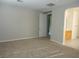 A bedroom with carpet and an open doorway leading to an ensuite bathroom at 7649 Slide Rock Ave, Las Vegas, NV 89113