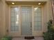 Inviting entryway with a sage-green door flanked by sidelight windows at 7649 Slide Rock Ave, Las Vegas, NV 89113