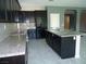 Well-equipped kitchen with an island, granite countertops and stainless steel appliances at 7649 Slide Rock Ave, Las Vegas, NV 89113