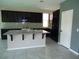 Open kitchen with a large island, granite countertops, and modern appliances at 7649 Slide Rock Ave, Las Vegas, NV 89113