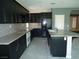 Gourmet kitchen with dark cabinetry, granite countertops, and stainless steel appliances at 7649 Slide Rock Ave, Las Vegas, NV 89113