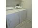 A laundry room with a white washer and dryer set at 7649 Slide Rock Ave, Las Vegas, NV 89113