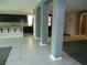 Open concept living space with gray accent walls and a kitchen in the background at 7649 Slide Rock Ave, Las Vegas, NV 89113