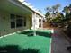 Cozy covered patio features an artificial turf surface, landscaped areas and elegant columns at 7649 Slide Rock Ave, Las Vegas, NV 89113