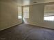Vacant secondary bedroom featuring neutral walls, carpet and three windows at 7971 Duneville St, Las Vegas, NV 89139