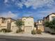 Two-story townhome with a two-car garage and neutral stucco finish with a red tile roof at 7971 Duneville St, Las Vegas, NV 89139