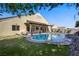 Beautiful backyard with a private pool and spacious covered patio area at 8125 Turbys Treehouse Pl, Las Vegas, NV 89131