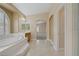 Bathroom featuring a large soaking tub and access to the main bedroom at 8125 Turbys Treehouse Pl, Las Vegas, NV 89131